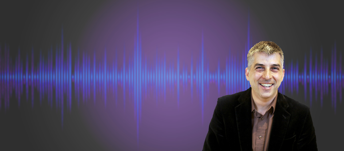 Professor Bryan Pardo in front of an audio waveform 